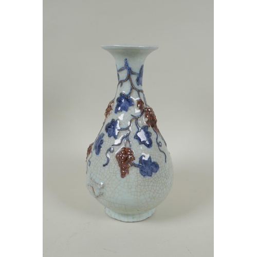 119 - A Chinese crackleware pear shaped vase with raised blue and red grape vine decoration, 25cm high