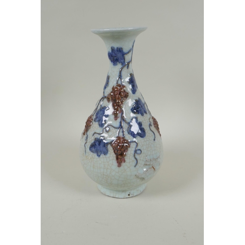 119 - A Chinese crackleware pear shaped vase with raised blue and red grape vine decoration, 25cm high