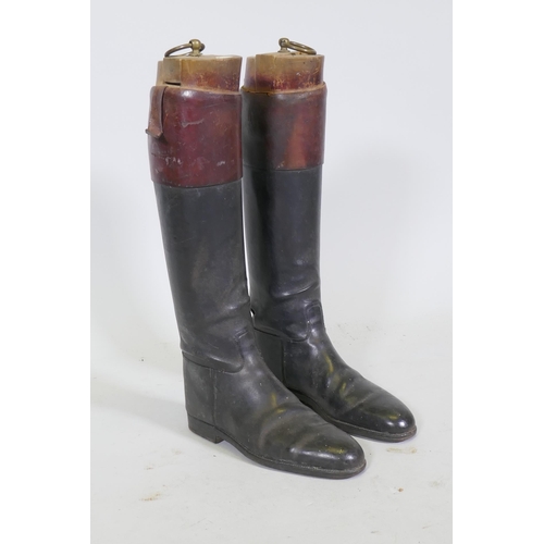 12 - A pair of vintage black and red riding boots with beechwood trees, labelled Maxwell, Dover St., Lond... 