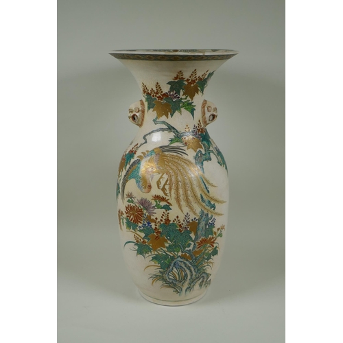 122 - A Japanese Meiji Satsuma vase, with twin mask handles, decorated with a phoenix in flight, 48cm high