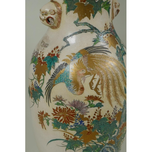 122 - A Japanese Meiji Satsuma vase, with twin mask handles, decorated with a phoenix in flight, 48cm high