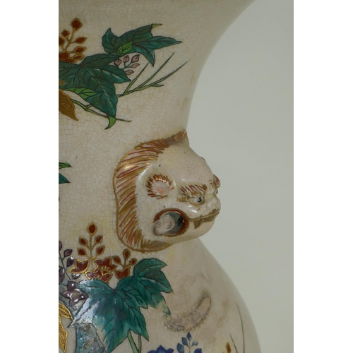 122 - A Japanese Meiji Satsuma vase, with twin mask handles, decorated with a phoenix in flight, 48cm high