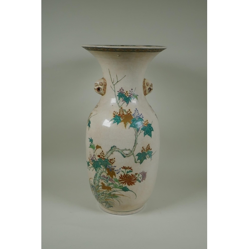 122 - A Japanese Meiji Satsuma vase, with twin mask handles, decorated with a phoenix in flight, 48cm high