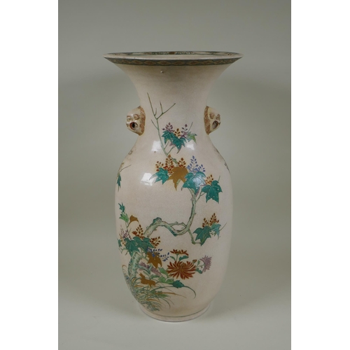 122 - A Japanese Meiji Satsuma vase, with twin mask handles, decorated with a phoenix in flight, 48cm high