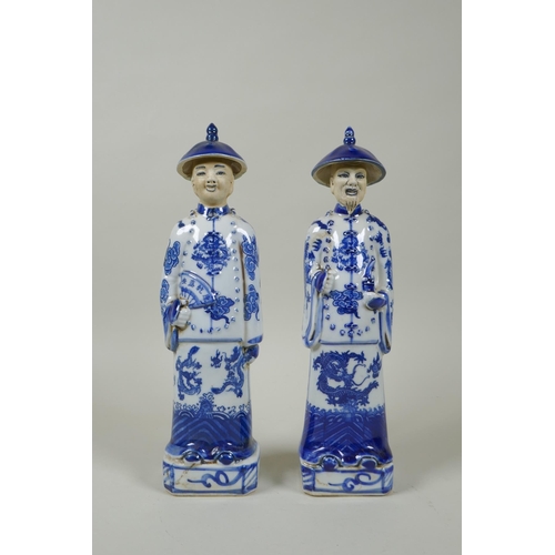 125 - A pair of Chinese Qing dynasty blue and white figures, impressed marks to base, 26cm high