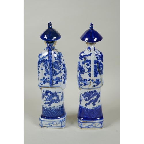 125 - A pair of Chinese Qing dynasty blue and white figures, impressed marks to base, 26cm high