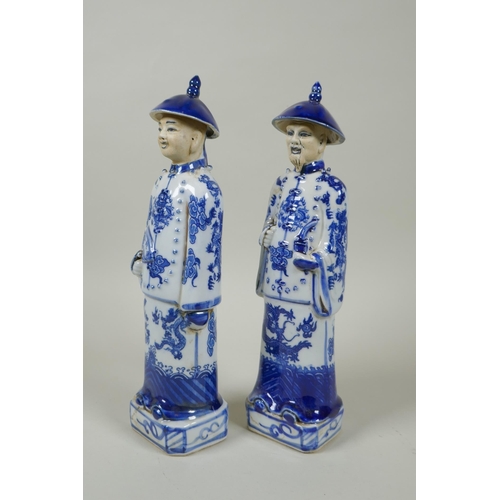 125 - A pair of Chinese Qing dynasty blue and white figures, impressed marks to base, 26cm high