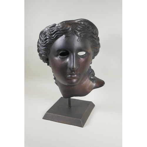 129 - A bronze head bust/mask of Aphrodite, on a display stand, 43cm high