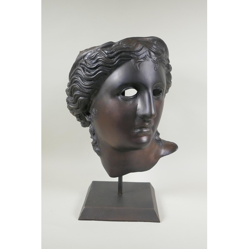 129 - A bronze head bust/mask of Aphrodite, on a display stand, 43cm high