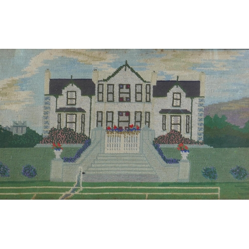 132 - An early C20th naive wool work of a country house and tennis court, 61 x 35cm