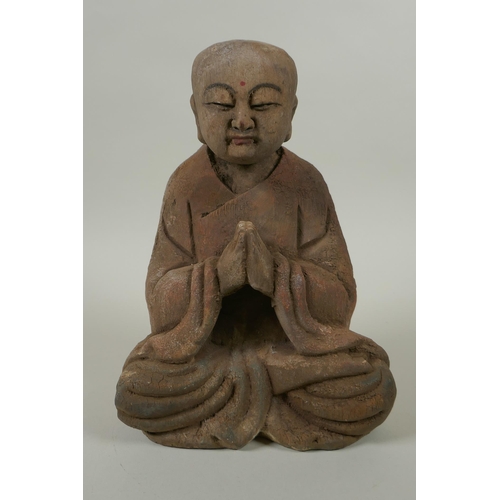 135 - A Chinese carved and painted wood figure of Buddha, 23cm high