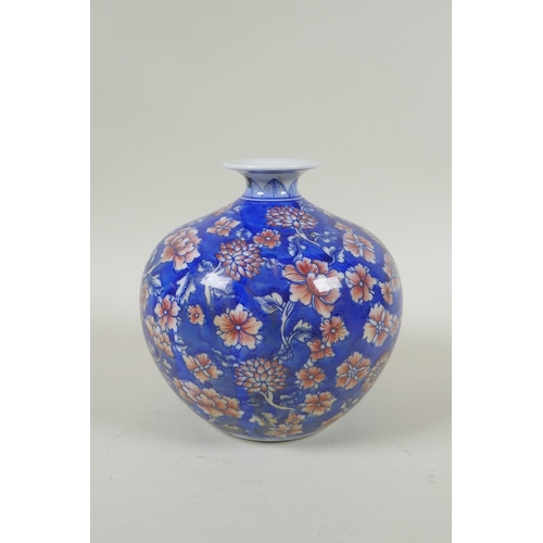 137 - A Chinese blue and white porcelain pomegranate shaped vase, with allover floral decoration and red h... 