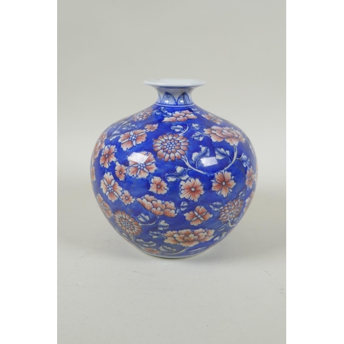 137 - A Chinese blue and white porcelain pomegranate shaped vase, with allover floral decoration and red h... 