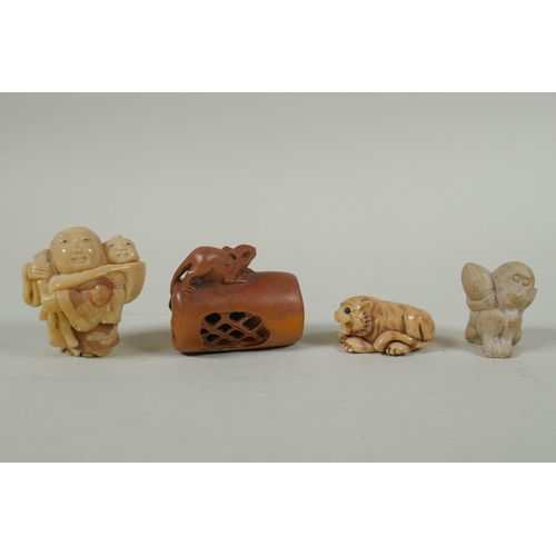 143 - A Japanese carved boxwood rat netsuke, together with two carved tagua nut netsuke in the form of a m... 