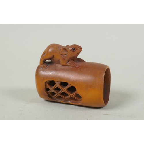 143 - A Japanese carved boxwood rat netsuke, together with two carved tagua nut netsuke in the form of a m... 