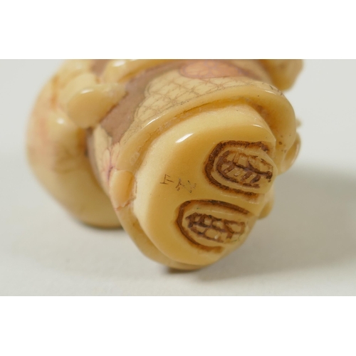 143 - A Japanese carved boxwood rat netsuke, together with two carved tagua nut netsuke in the form of a m... 