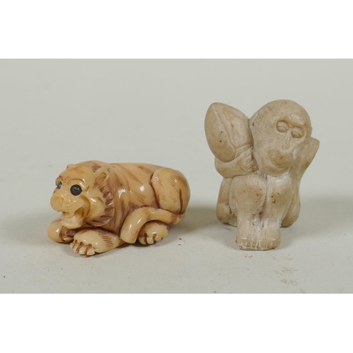 143 - A Japanese carved boxwood rat netsuke, together with two carved tagua nut netsuke in the form of a m... 