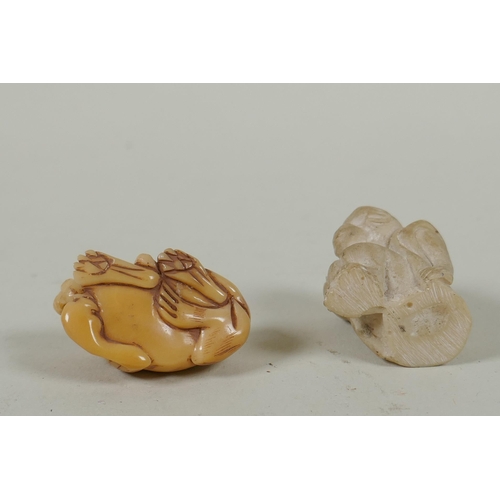 143 - A Japanese carved boxwood rat netsuke, together with two carved tagua nut netsuke in the form of a m... 