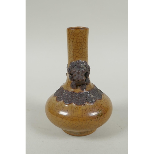 148 - An antique Chinese crackleware bottle vase with two lion mask loop handles, 13cm high