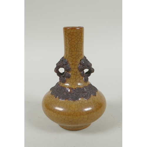 148 - An antique Chinese crackleware bottle vase with two lion mask loop handles, 13cm high