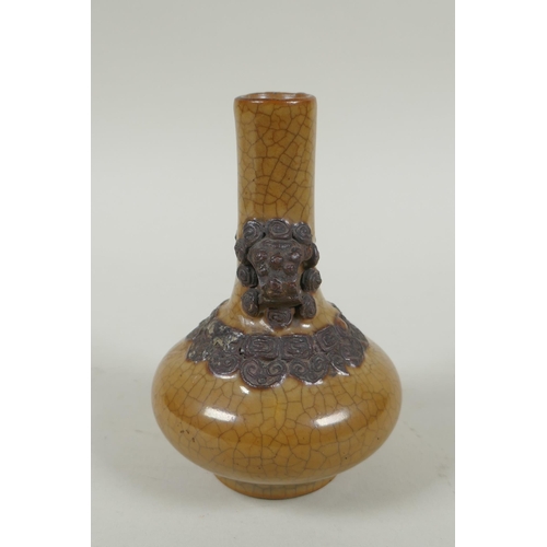 148 - An antique Chinese crackleware bottle vase with two lion mask loop handles, 13cm high