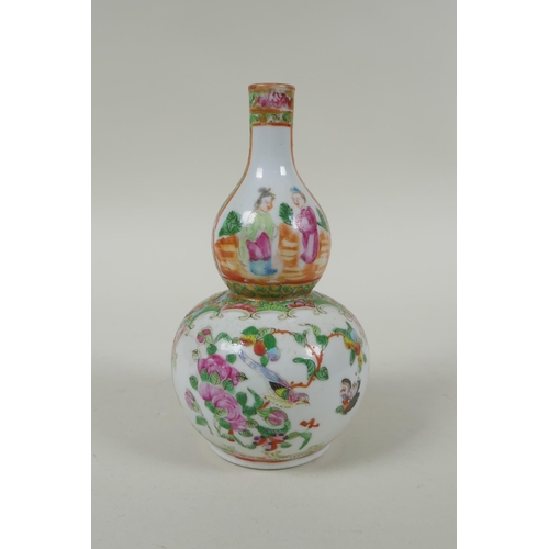 149 - A C19th Chinese Canton famille rose porcelain double gourd vase, with decorative panels depicting fi... 