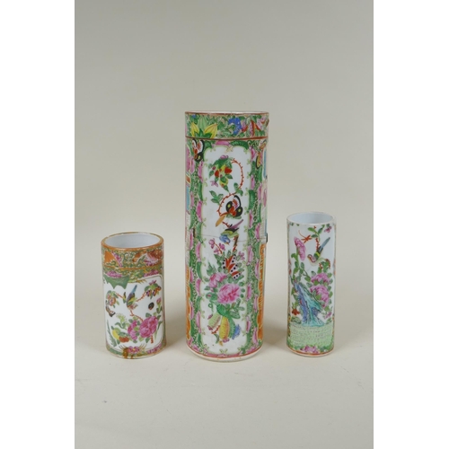 152 - A C19th Chinese Canton famille rose cylinder vase and two smaller, all with decorative panels depict... 