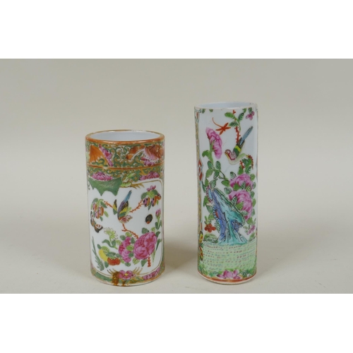 152 - A C19th Chinese Canton famille rose cylinder vase and two smaller, all with decorative panels depict... 