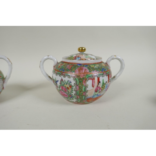 153 - A Chinese Republic Canton famille rose porcelain sugar pot, jug and two tea cups, largest 12cm diame... 