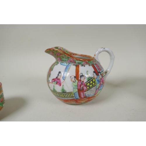 153 - A Chinese Republic Canton famille rose porcelain sugar pot, jug and two tea cups, largest 12cm diame... 