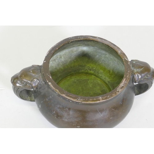 162 - A Chinese bronze censer with dragon mask handles, seal mark to base, 19cm diameter