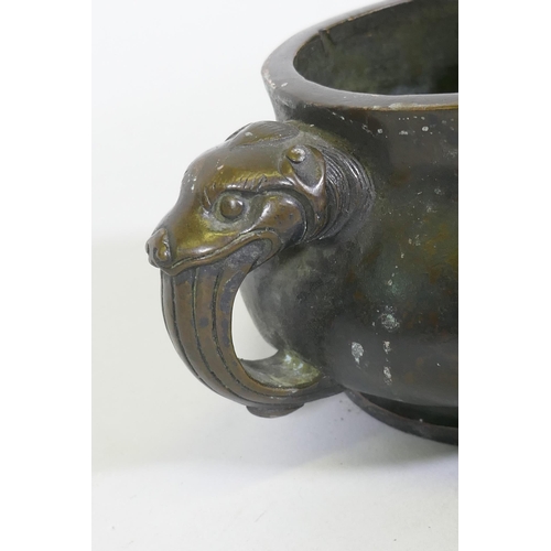 162 - A Chinese bronze censer with dragon mask handles, seal mark to base, 19cm diameter