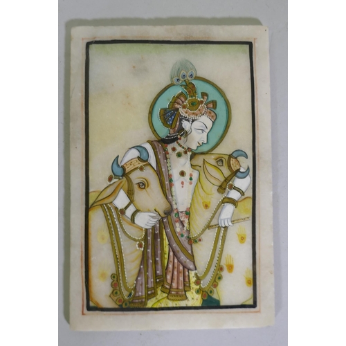 163 - An Indian painting of Krishna, bearing a flute and accompanied by two cows, enamels on marble tablet... 