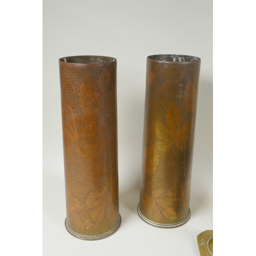 166 - A pair of WWI  brass trench art vases with berry vine decoration, an antique leather bound bras... 