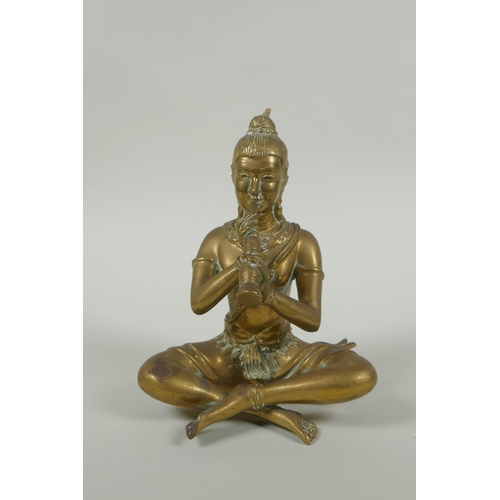 171 - A Cambodian bronze figure of a seated musician playing a flute, 15cm high