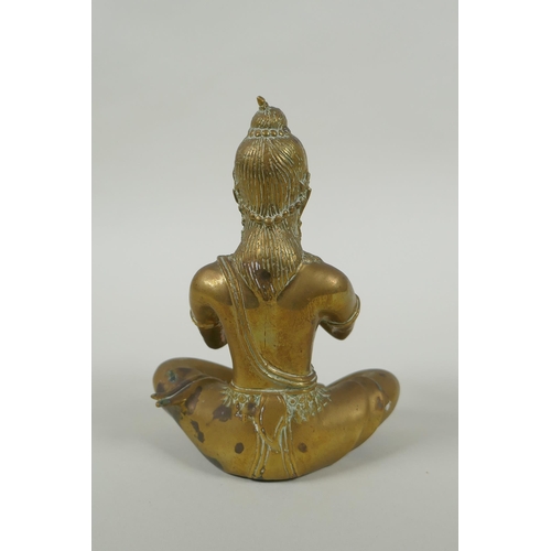 171 - A Cambodian bronze figure of a seated musician playing a flute, 15cm high