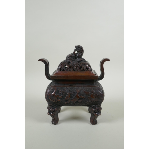 180 - A Chinese bronze two handles censer and cover, with allover kylin decoration and lion mask feet, sea... 