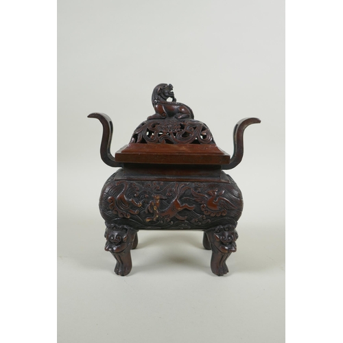 180 - A Chinese bronze two handles censer and cover, with allover kylin decoration and lion mask feet, sea... 