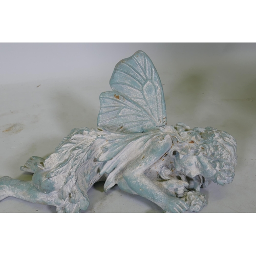 181 - A cast iron garden figure of a sleeping fairy, 42cm long