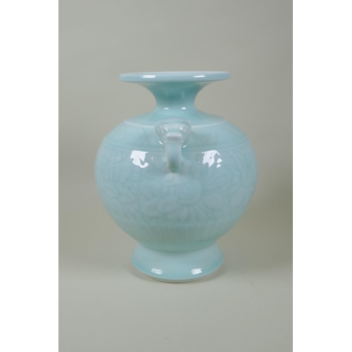 183 - A Chinese celadon glazed porcelain vase with two elephant mask handles and underglaze floral decorat... 