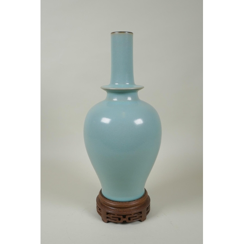 186 - A Chinese Ru ware style porcelain vase, on a carved wood stand, 33cm high