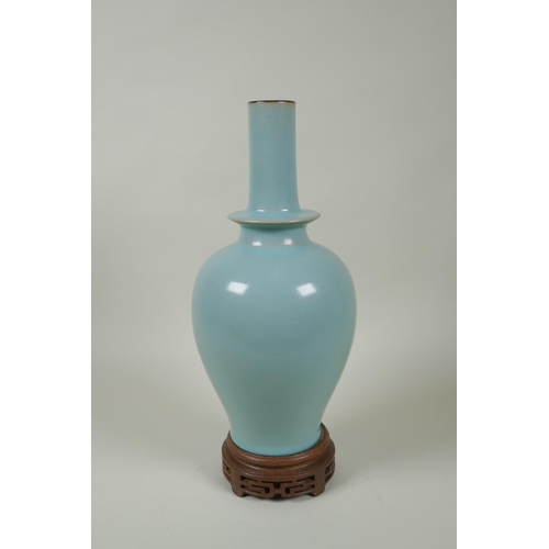 186 - A Chinese Ru ware style porcelain vase, on a carved wood stand, 33cm high