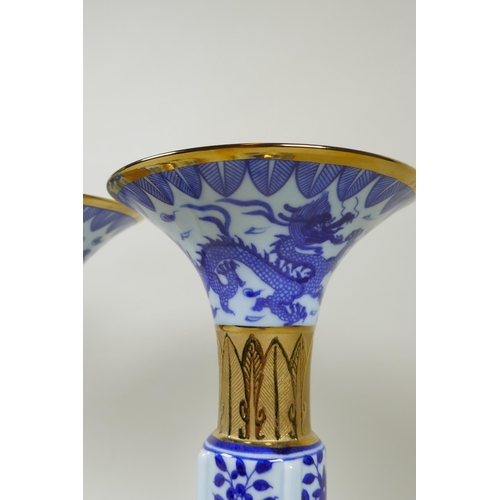 188 - A pair of Chinese blue and white gu shaped vases with banded gilt highlights, and decorated with pho... 