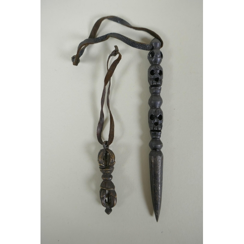 191 - A Tibetan steel phurba with skull mask decorated to the handle and a miniature bronze vajra, 14cm lo... 