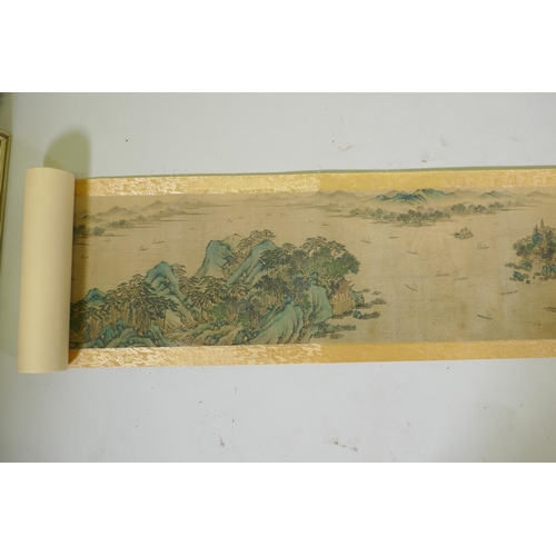 193 - A Chinese printed watercolour scroll depicting an extensive riverside landscape, 29cm high