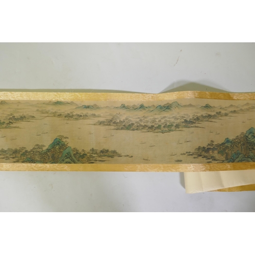 193 - A Chinese printed watercolour scroll depicting an extensive riverside landscape, 29cm high