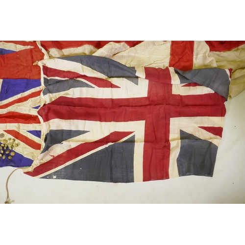 194 - Four vintage British Naval flags to include two Union Jacks, a white St George's cross ensign and a ... 