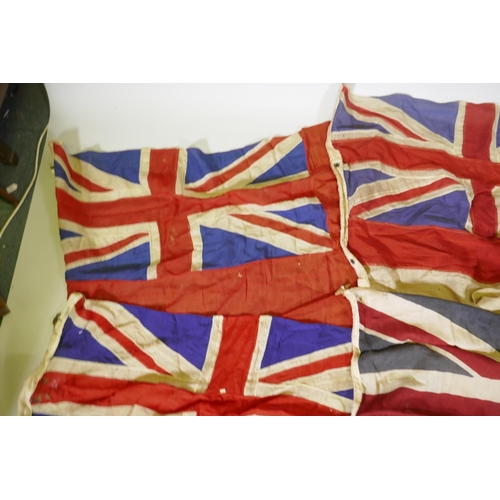 194 - Four vintage British Naval flags to include two Union Jacks, a white St George's cross ensign and a ... 