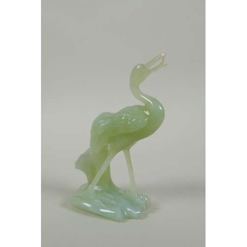 195 - A Chinese green jade carving of a crane, 16cm high