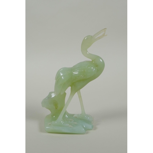 195 - A Chinese green jade carving of a crane, 16cm high